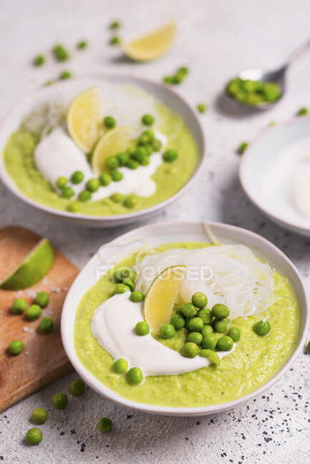 Cream soup with zucchini, green peas and rice noodles — Stock Photo