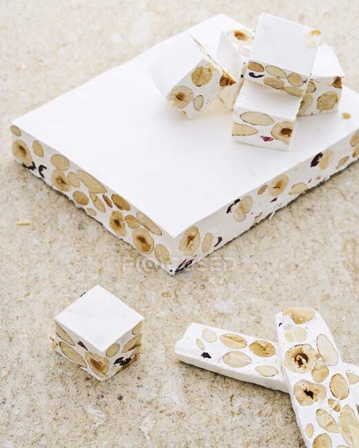 White nougat with nuts on a stone background — Stock Photo