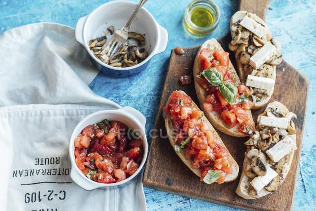 White chiabatta bread cut with toppings, tomato and mushrooms with brie cheese — Stock Photo