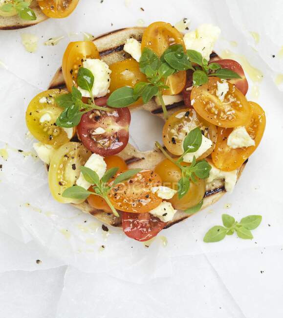 Grilled bagel with cherry tomatoes and feta cheese — Stock Photo