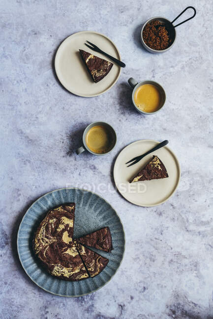 Tahini Brownies baked in round cake tin served with coffee — Stock Photo