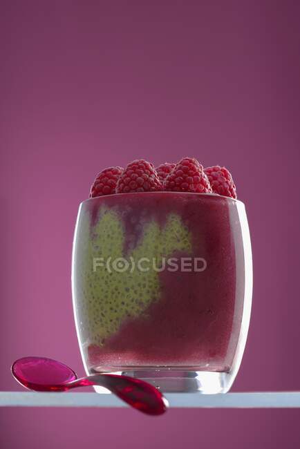 Matcha chia pudding with raspberry puree in a glass — Stock Photo