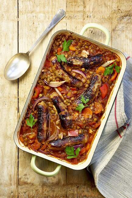 Lentil casserole with sausages, carrots and onions — Stock Photo