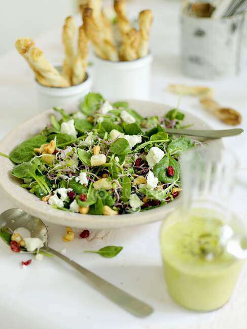 Green salad with sprouts, feta and cashews — Stock Photo