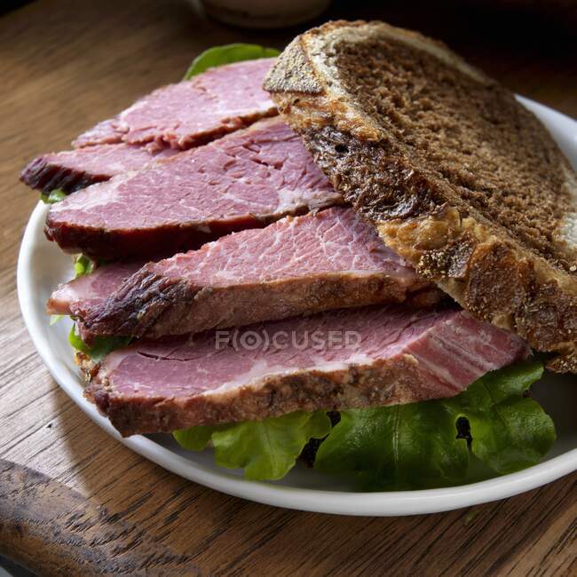 Corned beef sandwich on marble rye with lettuce — Stock Photo