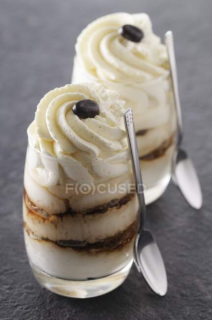Tiramisu served in dessert glasses with spoons — Stock Photo