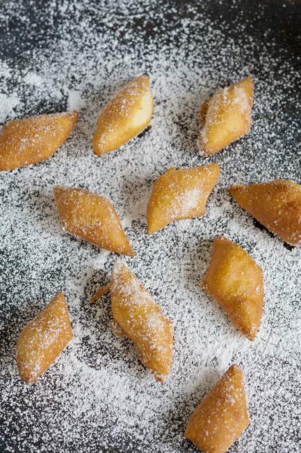 Fasnetskchle (mini cakes), with icing sugar on a metal sheet — Stock Photo