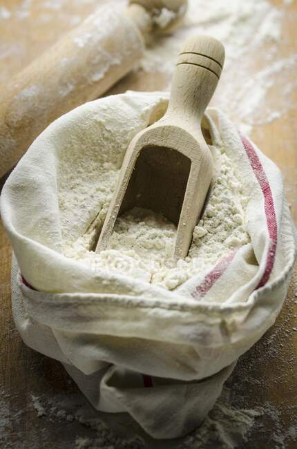 A sack of flour with a scoop — Stock Photo