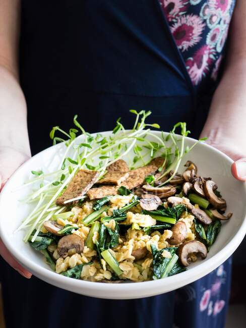 Rolled oats with mushrooms, tempeh and pea sprouts — Stock Photo