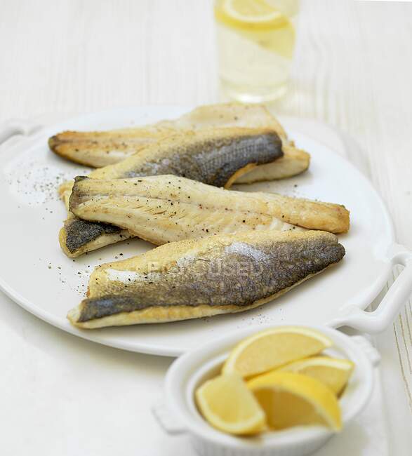 Sea bass fillets with lemon — Stock Photo