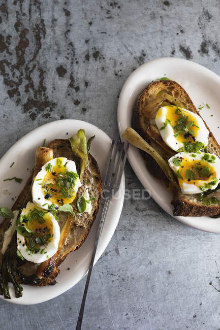 Tostadas con huevo y puerro servidas en mini platos - foto de stock