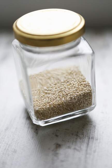 Quinoa in a screw-top jar — стокове фото