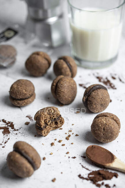 Baci di dama homemade Italian hazelnut biscuits with chocolate filling served with espresso coffee and milk — Stock Photo