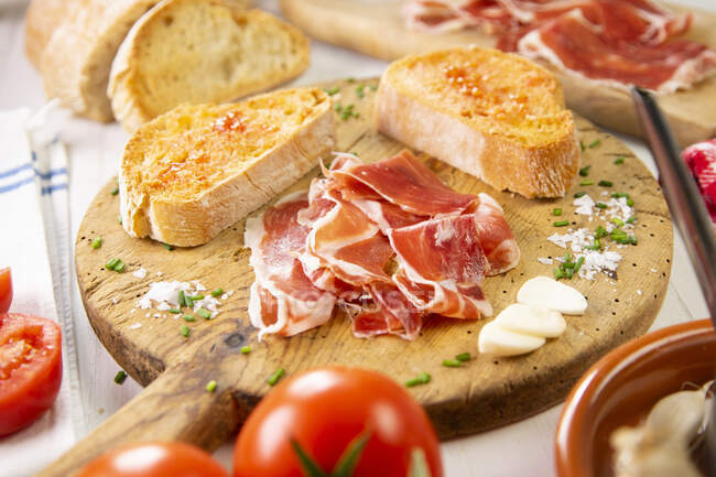 Sandwich with prosciutto and bacon on plate, closeup — Stock Photo