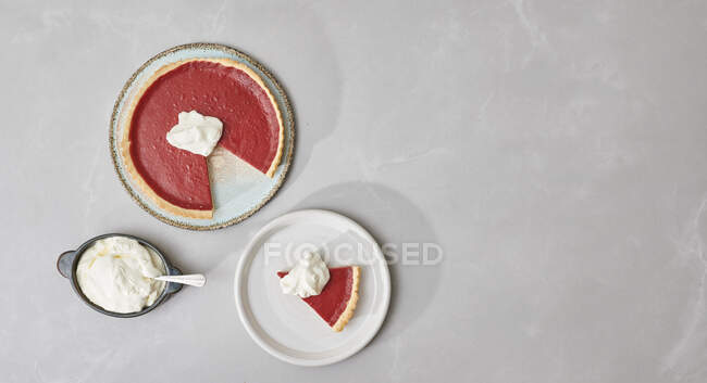 Torta di mirtilli rossi, tagliata e servita con panna — Foto stock