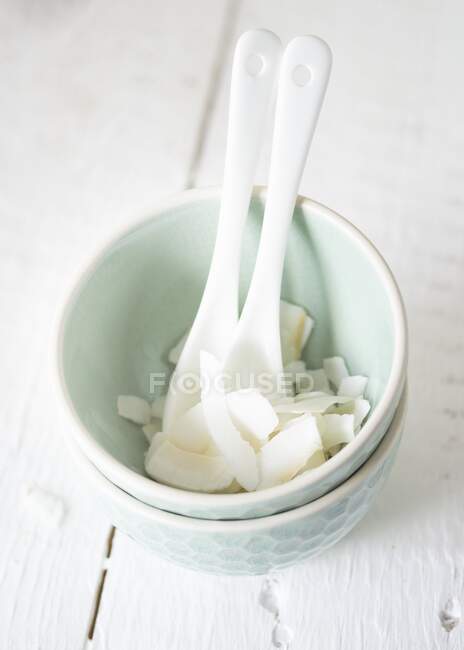 Coconut chips in granola with plastic spoon — Stock Photo