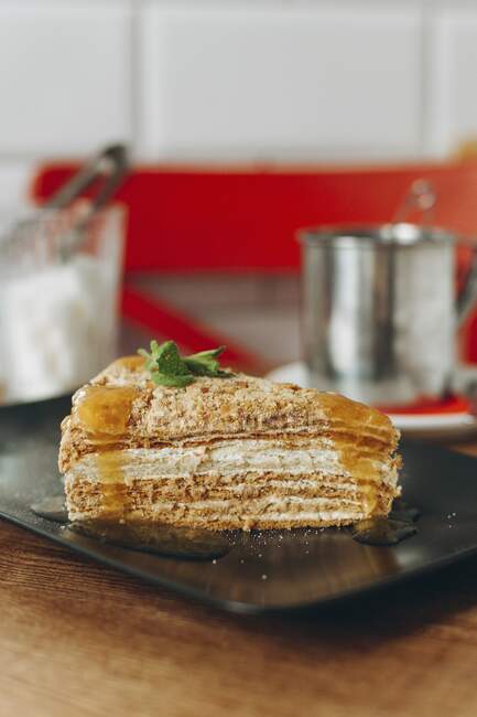 A piece of layered cake on a plate — Stock Photo