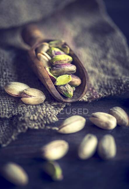 An arrangement of pistachios on a wooden scoop — Stock Photo
