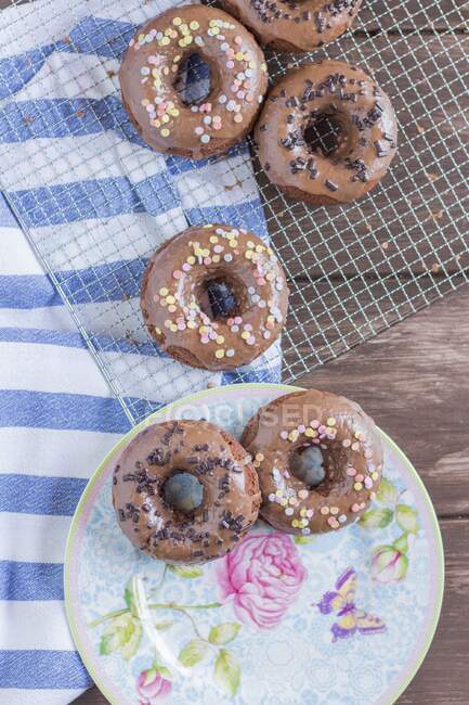 Nutella doughnuts with sugar confetti and chocolate sprinkles — Stock Photo