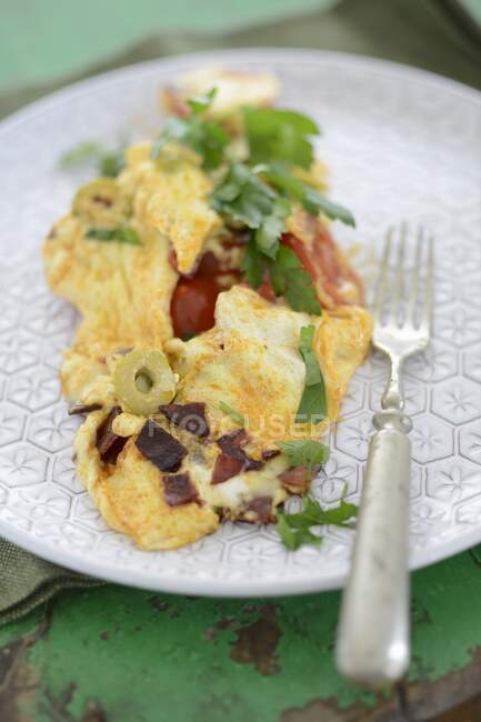 An omelette with olives and bacon — Stock Photo