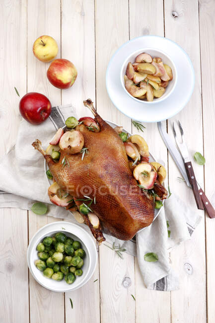 Baked goose with apples and brussels sprout — Stock Photo