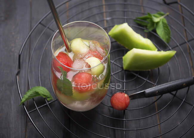 Fizzy white wine Sangria with watermelon and melon balls — Stock Photo