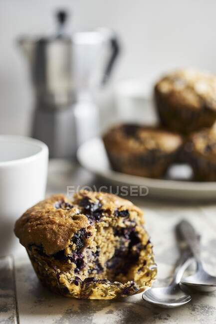 A blueberry muffin with a bite taken out (close up) — Stock Photo