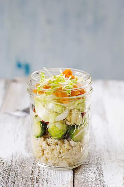 Salad in a glass with couscous, brussels sprouts, apple, chicory, carrot and lentil sprouts — Stock Photo