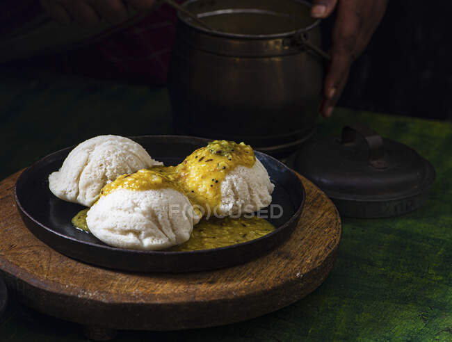 Idli und Sambar (gedämpfter Kuchen mit Linsen- und Tamarindensoße) — Stockfoto