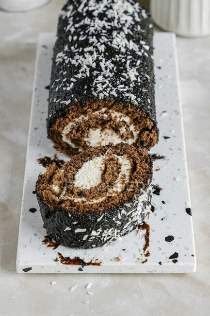 Chocolate roll with vanilla coconut cream — Stock Photo