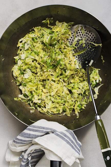 Fried spring cabbage in a wok — Stock Photo
