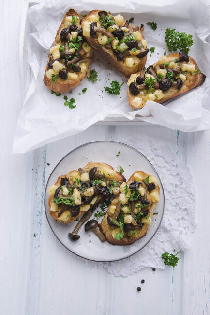 Toasted bread with brown beech mushrooms and potatoes pieces — Stock Photo