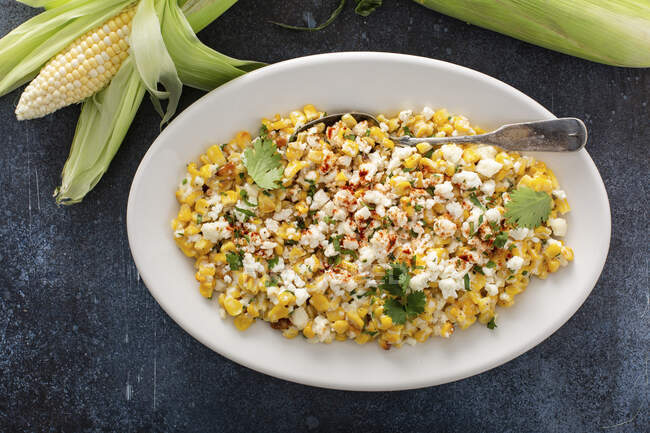 Mexican street corn, elote with cotija cheese, fresh cilantro and chili — Stock Photo