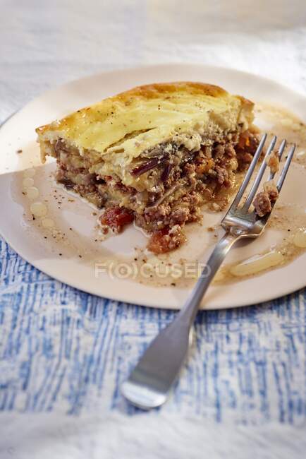 A slice of moussaka on a plate — Stock Photo