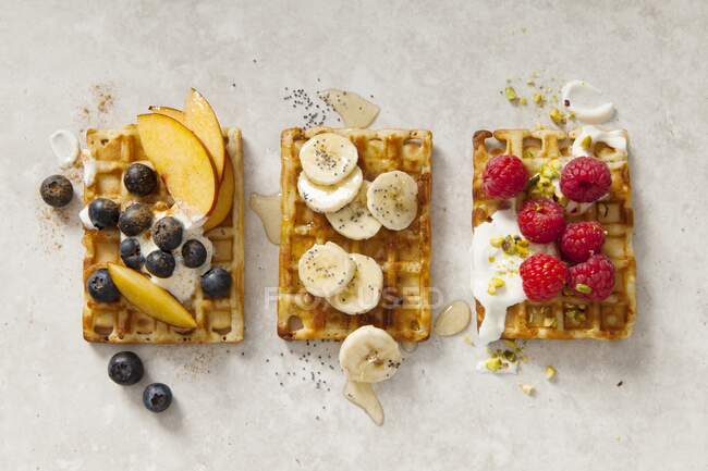 Belgian waffles with three different toppings (seen from above) — Stock Photo