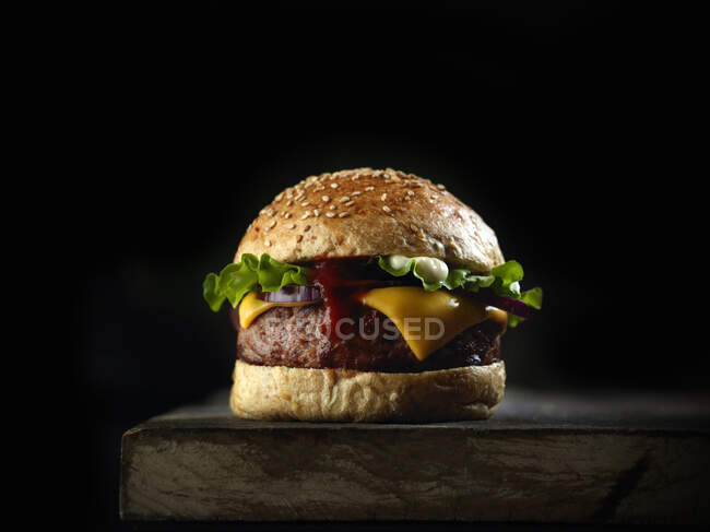 Fresh tasty burger on black background — Stock Photo
