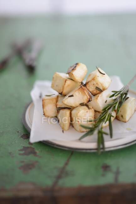 Fried celery cubes with rosemary — Stock Photo