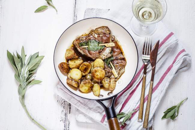 Meat steaks with fried potatoes and herbs — Stock Photo
