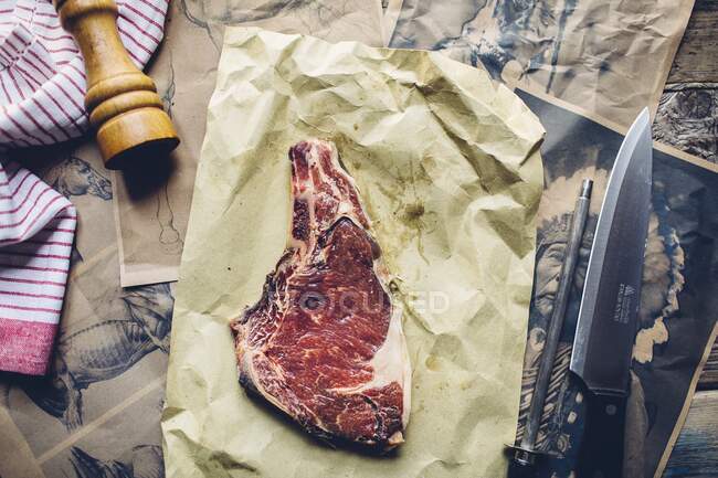 A raw horse steak on baking paper — Stock Photo