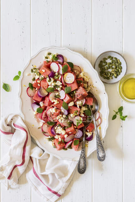 Watermelon, radish, feta, red onion and pepita seeds salad — Stock Photo