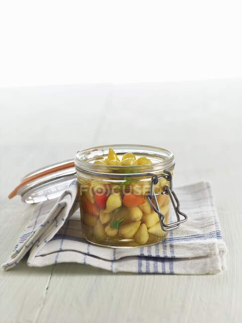Lacto fermented mini peppers with tarragon in a mason jar — Stock Photo