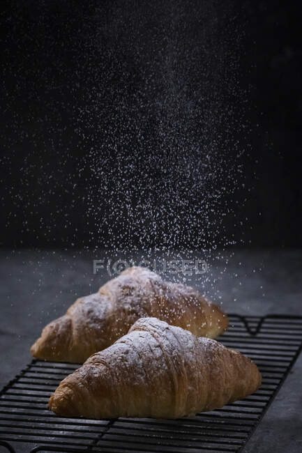 Croissant with powdered sugar — Stock Photo