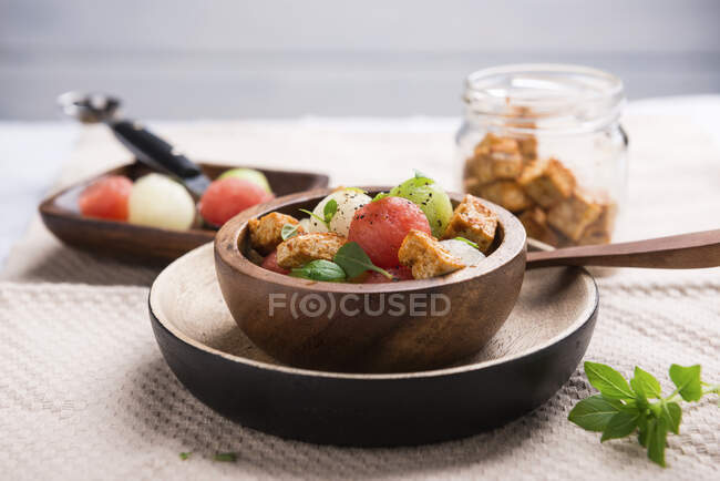 Tofu and melon salad in mini wooden bowl — Stock Photo