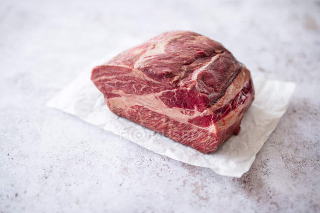 Full Blood Wagyu beef (neck) on parchment paper — Stock Photo
