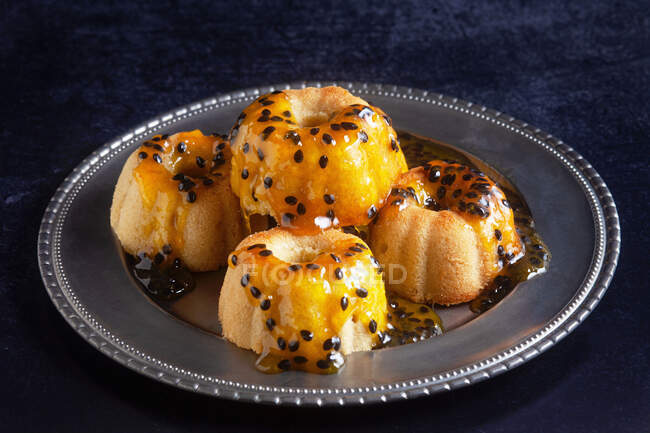 Lemon cakes with passion fruit syrup — Stock Photo