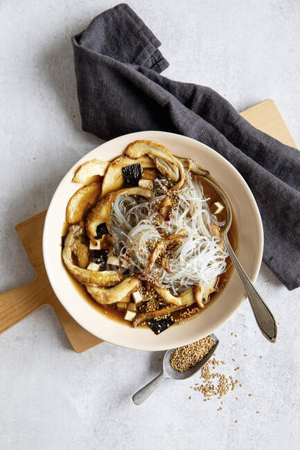 Mushroom soup with glass noodles and sesame seeds — Stock Photo