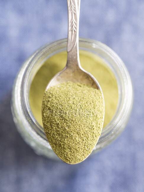 Moringa powder on a spoon — Stock Photo