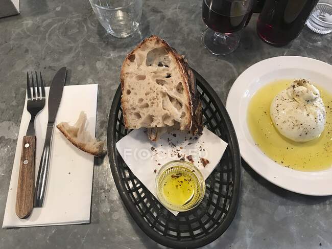 Sourdough bread with olive oil on a restaurant counter (Italy) — стокове фото