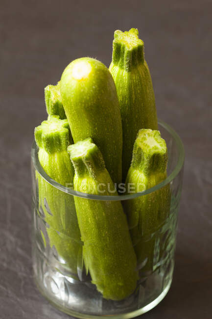 Fresh green zucchini on a wooden background — Stock Photo