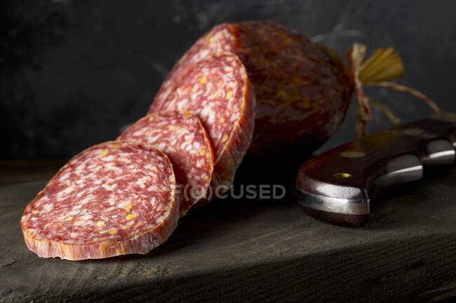Beef salami slices on a wooden board — Stock Photo